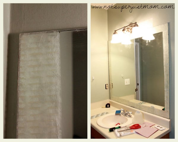 A strip of adhesive tile mat pressed onto the edge of the mirror with its clear protective film still in place