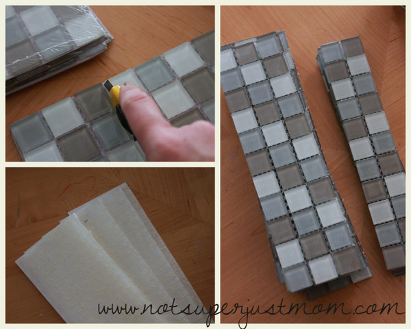 A twelve-inch sheet of mesh-backed mosaic tile being cut into a narrow strip with a box knife