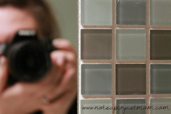 A close view of the finished tile border showing the mix of tile colors and the even grout lines between them