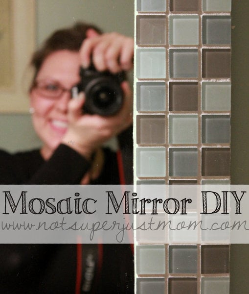 Setting a strip of small mosaic tiles into place by hand at a tiling workshop