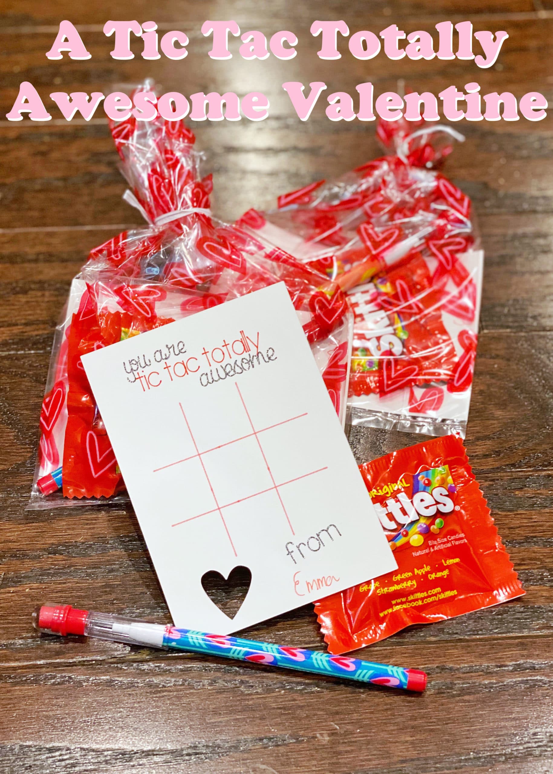 This is an image of a custom Valentine featuring a tic tac toe board, a small package of Skittles, and a pencil.